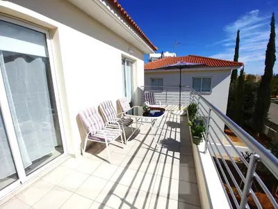 a balcony with two chairs and a table on a house at AP10 Mythical Sands in Protaras
