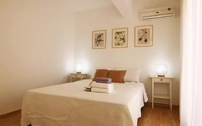 a white bedroom with a bed and two night stands at Phaedrus Living Luxury Flat Protaras Sea View 9 in Protaras
