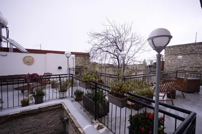 a balcony with potted plants and a street light at Lazaros Stonehouse in Pano Lefkara