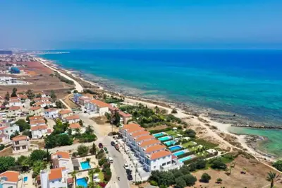 an aerial view of a beach with houses and the ocean at Villa Ivory - Seafront in Ayia Napa