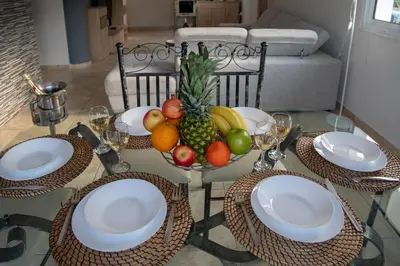 a table with a bowl of fruit on it at Villa Ruby Nissi Beach in Ayia Napa