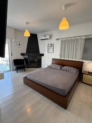 a bedroom with a large bed and a piano at Top floor apartment in Nicosia with view! in Nicosia