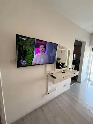 a flat screen tv on a wall in a living room at Top floor apartment in Nicosia with view! in Nicosia