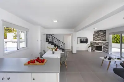 a kitchen and living room with a fireplace at Villa Alleli in Protaras