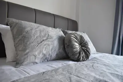 a bed with two pillows on top of it at Marias Apartment - in city centre,near beach in Larnaka