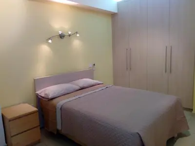 a bedroom with a bed and a cabinet at 3 Bedroom Apartment in Nicosia