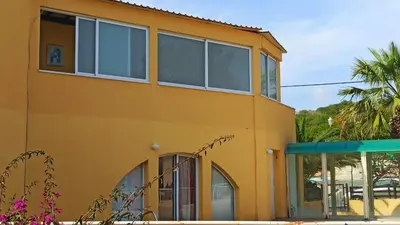 a yellow building with windows on the side of it at Holidays in Cyprus in Ayia Napa