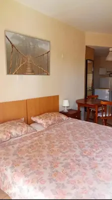 a bedroom with a bed with a bridge painting on the wall at Olimpus Garden Homes in Ayia Napa
