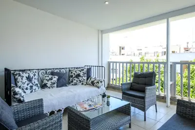 a living room with a couch and a chair at Lovely 2 BR Vacation Apt Kohili Beach - 3 Min Walk in Paralimni