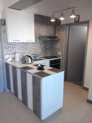 a kitchen with white cabinets and a counter top at Amazing Sea Place in Limassol