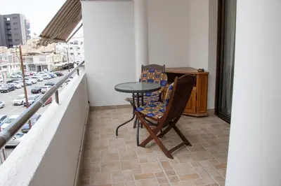 a table and two chairs on a balcony with a street at Apartment,NEAR THE BEACH Pinikoudes in Larnaka