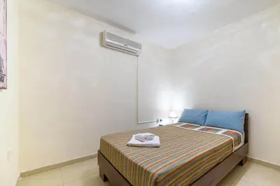 a bedroom with a bed with a towel on it at Protaras Centro Villa in Protaras