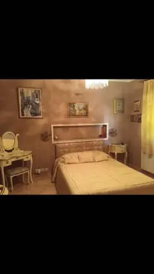 a bedroom with a large bed and a table at Villa Natalia in Ayia Napa