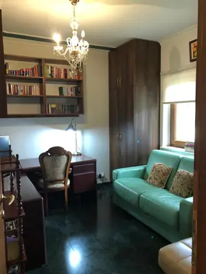 a living room with a green couch and a desk at Villa Natalia in Ayia Napa