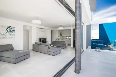 a living room with two couches and a swimming pool at Ocean 11 Villa in Protaras
