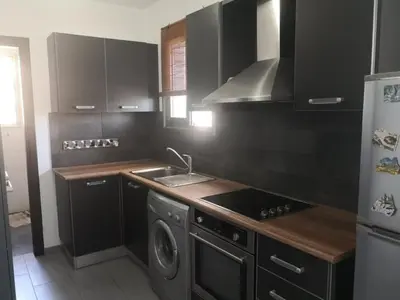 a kitchen with a stove and a sink and a refrigerator at Loizou Holdings Flat 301 in Larnaka