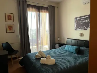 a bedroom with a bed with towels and a window at Klimentos Flat 58 in Nicosia