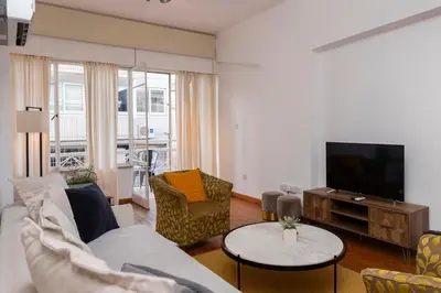a living room with a couch and a tv at 1-80 Collection by TrulyCyprus in Limassol