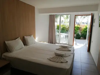 a bedroom with a bed with two pillows on it at JOY Hotel Apts in Ayia Napa
