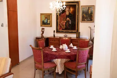 a dining room with a table with red chairs at Luxury Apartment, near Pinikoudes beach in Larnaka