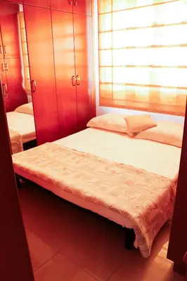 a small bedroom with two beds and a window at Luxury Apartment, near Pinikoudes beach in Larnaka