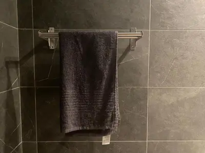 a black towel hanging on a towel rack in a bathroom at Luxury Lavender in Larnaka
