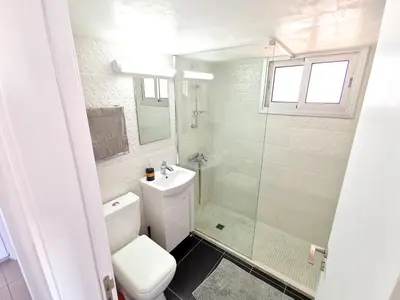 a bathroom with a toilet and a sink and a shower at Mackenzie Seaview Paradise in Larnaka