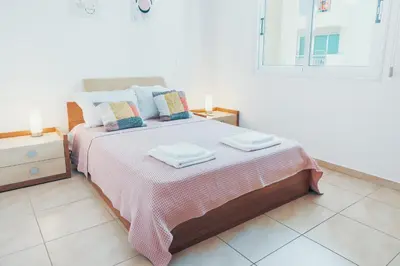a bedroom with a bed with two towels on it at Elegant 1 Bedroom Apartment - Great Kings Resort Protaras, Kapparis in Paralimni