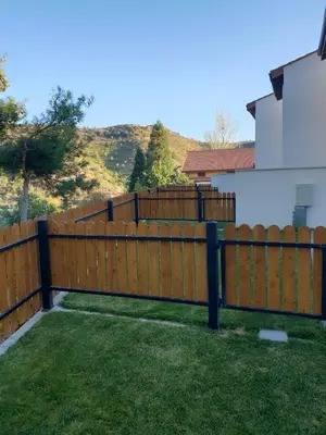 a wooden fence in front of a house at Melissonas Villas in Phini