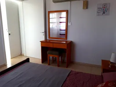 a bedroom with a dressing table and a mirror at La Veranda Sea View apartments in Larnaka