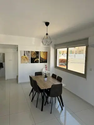 a dining room with a wooden table and chairs at Villa Naxos in Protaras