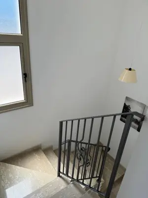 a staircase with a lamp and a window at Villa Naxos in Protaras