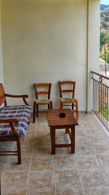 two chairs and a coffee table on a balcony at Το Σπίτι του Προκόπη in Nicosia