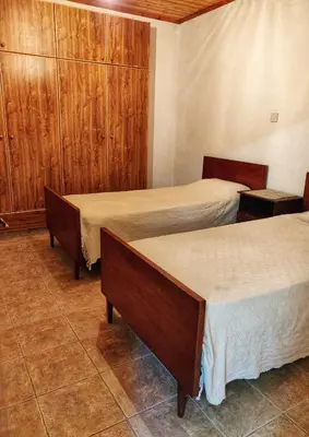 a room with two beds and wooden cabinets at Το Σπίτι του Προκόπη in Nicosia