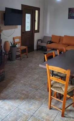 a living room with a table and chairs and a couch at Το Σπίτι του Προκόπη in Nicosia