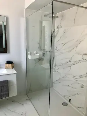 a shower with a glass door in a bathroom at Angel Suites in Nicosia