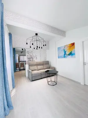 a living room with a couch and a table at SANDY BAY Villa in Ayia Napa