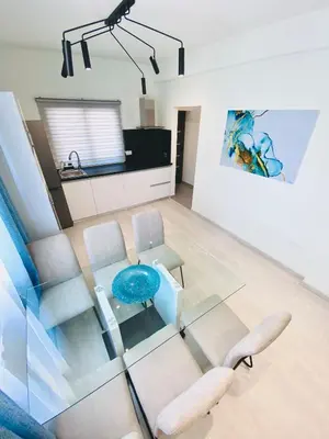 a living room with a glass table and chairs at SANDY BAY Villa in Ayia Napa