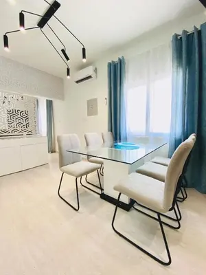 a dining room with a glass table and chairs at SANDY BAY Villa in Ayia Napa
