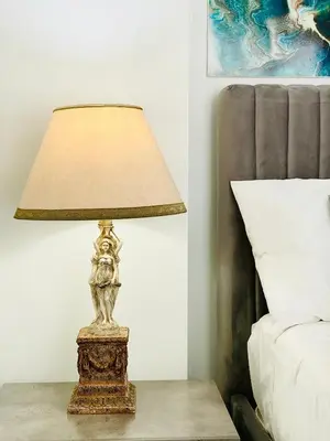 a lamp on a table next to a bed at SANDY BAY Villa in Ayia Napa