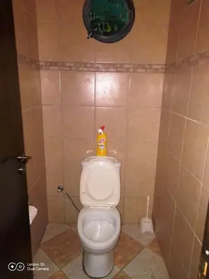 a bathroom with a toilet with a bottle on it at -= Studio Love =- in Xylophaghou