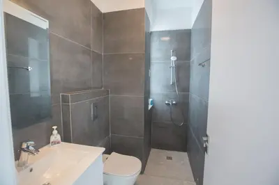 a bathroom with a shower and a toilet and a sink at Vie Bleu Villas in Protaras