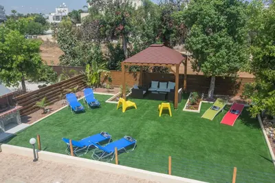 an aerial view of a backyard with chairs and a gazebo at Ariella Villa in Protaras
