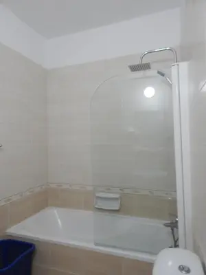 a bath tub in a bathroom with a mirror at BarLee's Apartment in Paralimni