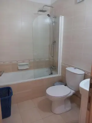a bathroom with a toilet and a shower and a sink at BarLee's Apartment in Paralimni