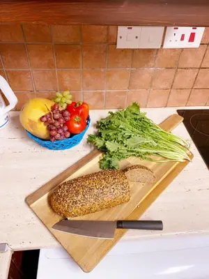 a cutting board with corn and vegetables on a counter at City Comfort Rooms in Larnaka