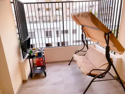 a room with a chair and a large window at City Comfort Rooms in Larnaka