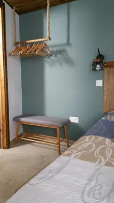 a bench in a room next to a bed at Magdalene's City House Inn in Larnaka
