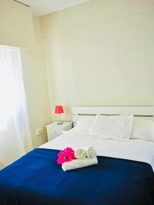 a bedroom with a bed with two towels and two rings at Kareem flat in Larnaka