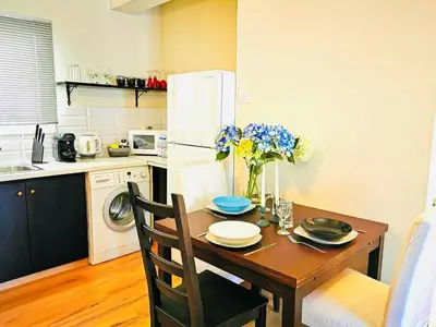 a kitchen with a table with plates and flowers on it at Kareem flat in Larnaka